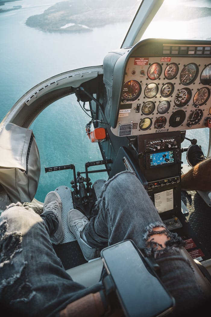 View from helicopter cockpit over Miami with ocean below, showcasing aviation controls and scenery.